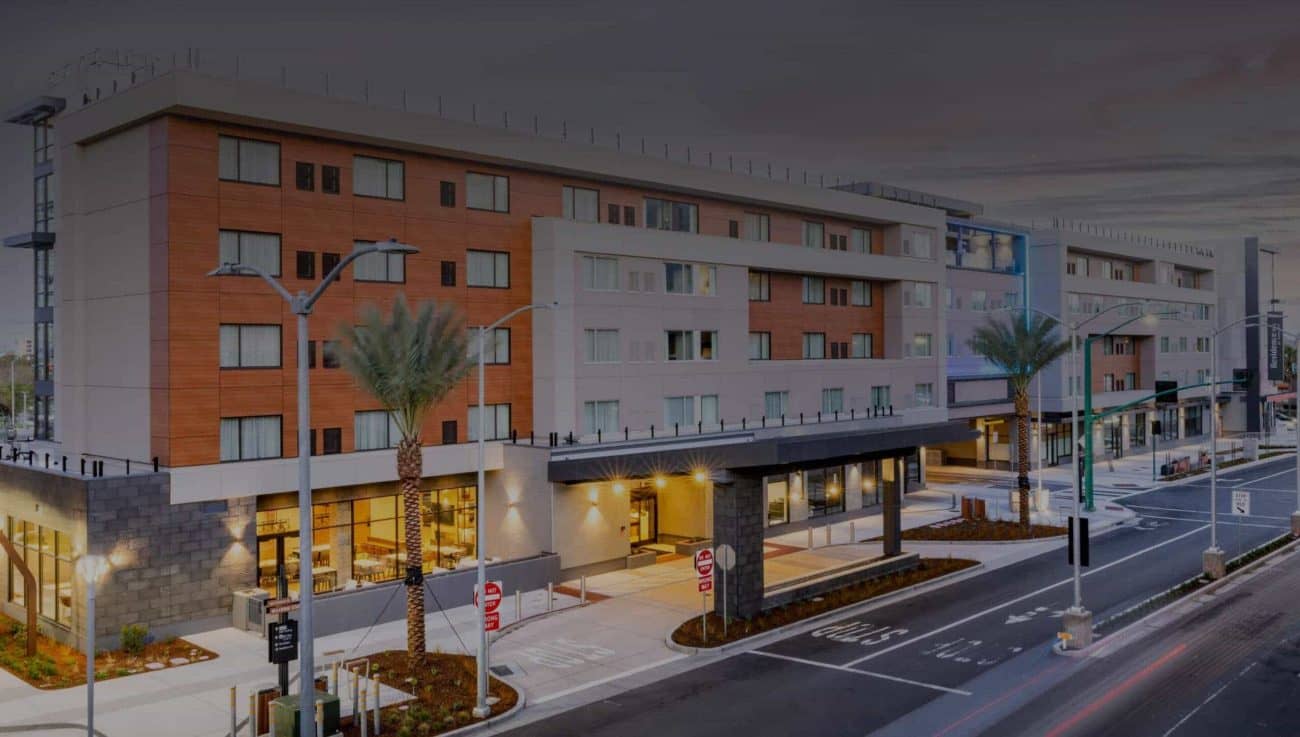 Image of side view of hotel with dark overlay