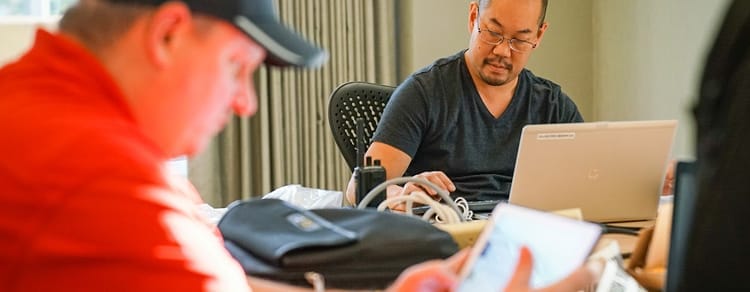 close-up of two gentleman using technology