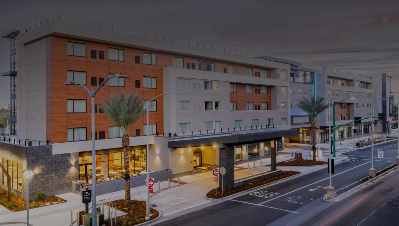 Image of side view of hotel with dark overlay